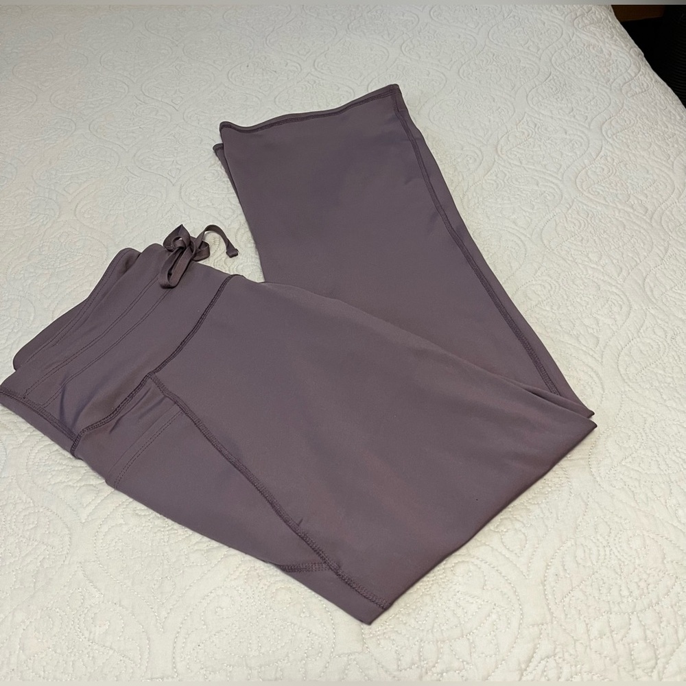 NYC “Like New” worn once, ladies size XL boot leg leggings in plum/silver color.